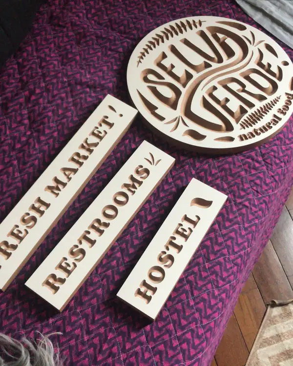 Hand-lettered wooden signs for Selva Verde