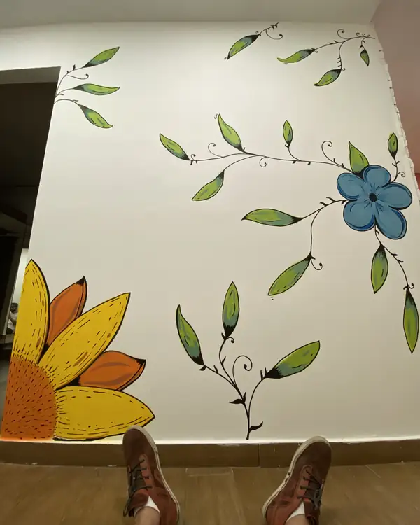 Sunflower and leaves on a white interior wall